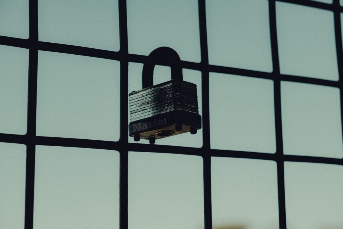 Concluding Labor Contracts with Foreigners in Vietnam — Key Notes for FDI Enterprises 4 Steel padlock on a wire mesh fence
