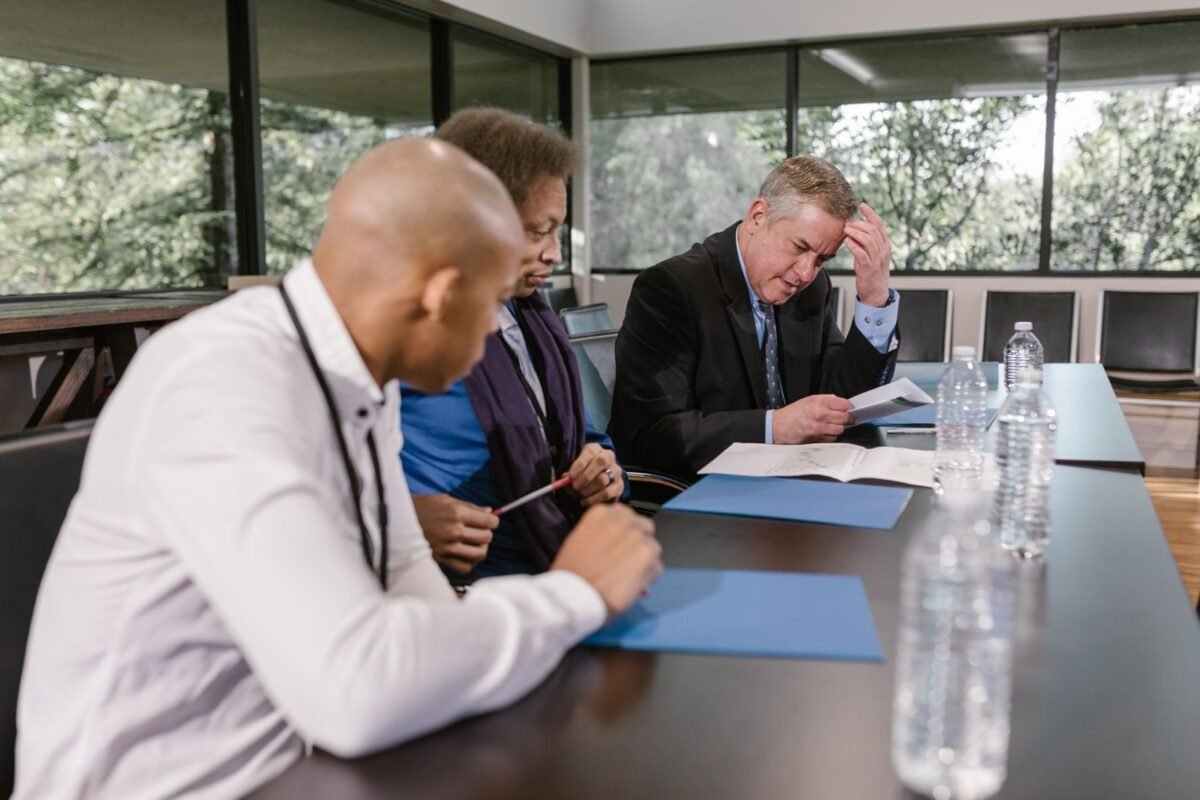 Colleagues reviewing documents in a business meeting