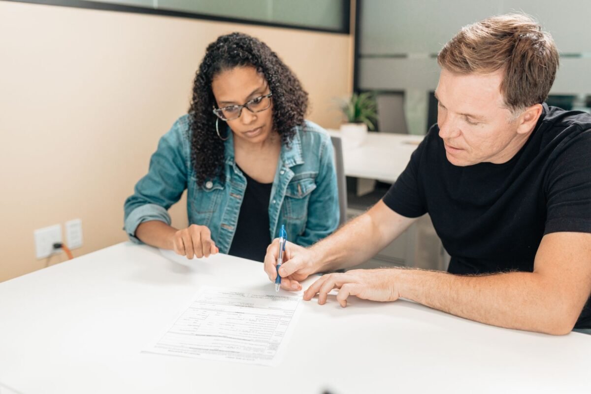 Couple signing legal documents at a desk