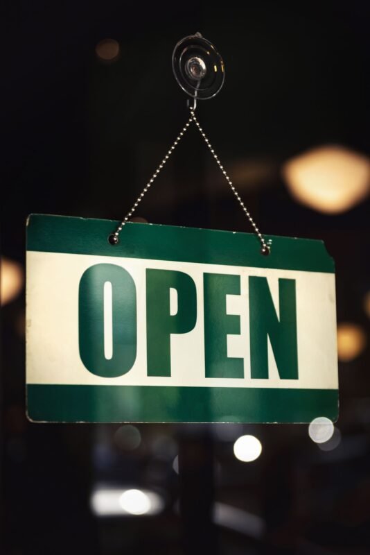 Blue Open sign hanging on a door