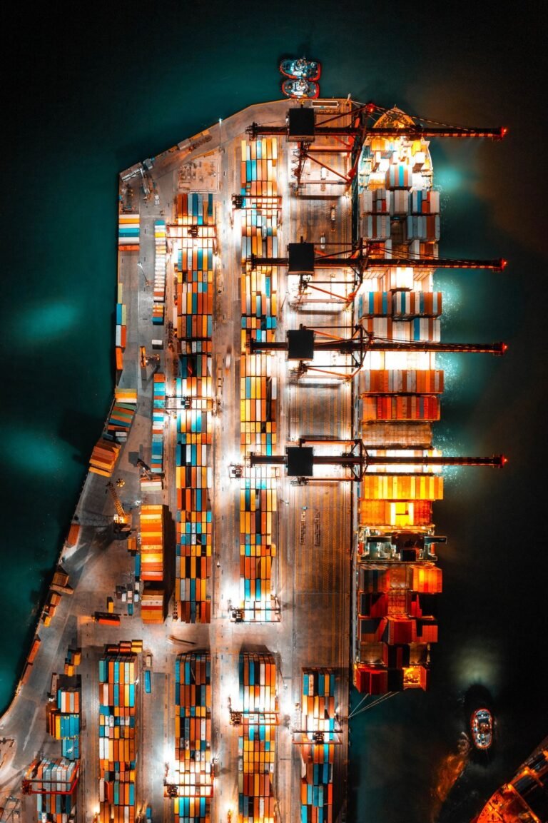 Aerial night view of a busy container port, illustrating goods exports to the UK.