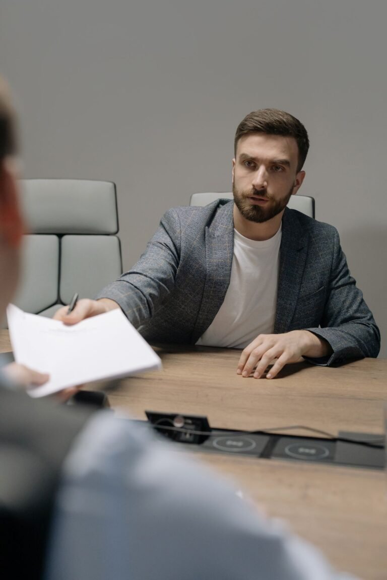 A man negotiating across a table in a modern office, illustrating labor dispute resolution