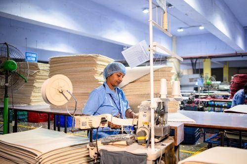 Workers inside a manufacturing workshop (illustrative)