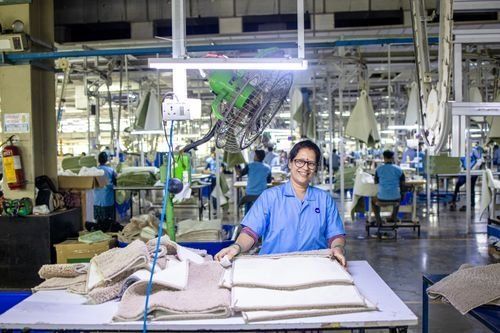 Workers inside a manufacturing plant (illustrative)