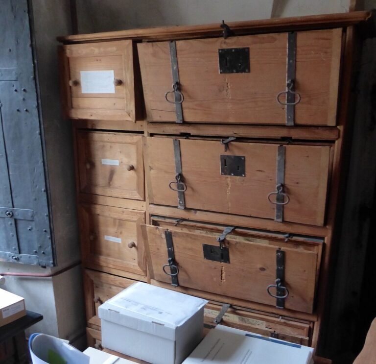 Wooden archive boxes holding documents on storage shelves