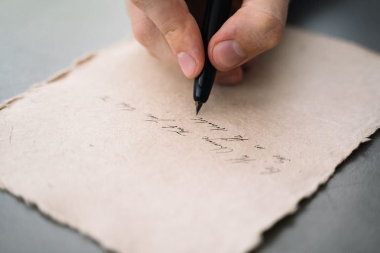 Close-up shot of a person writing on paper