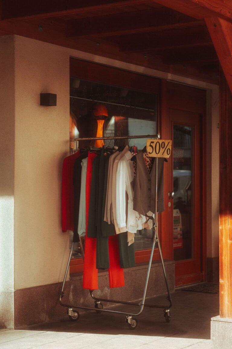 Outdoor rack of garments marked 50 percent off