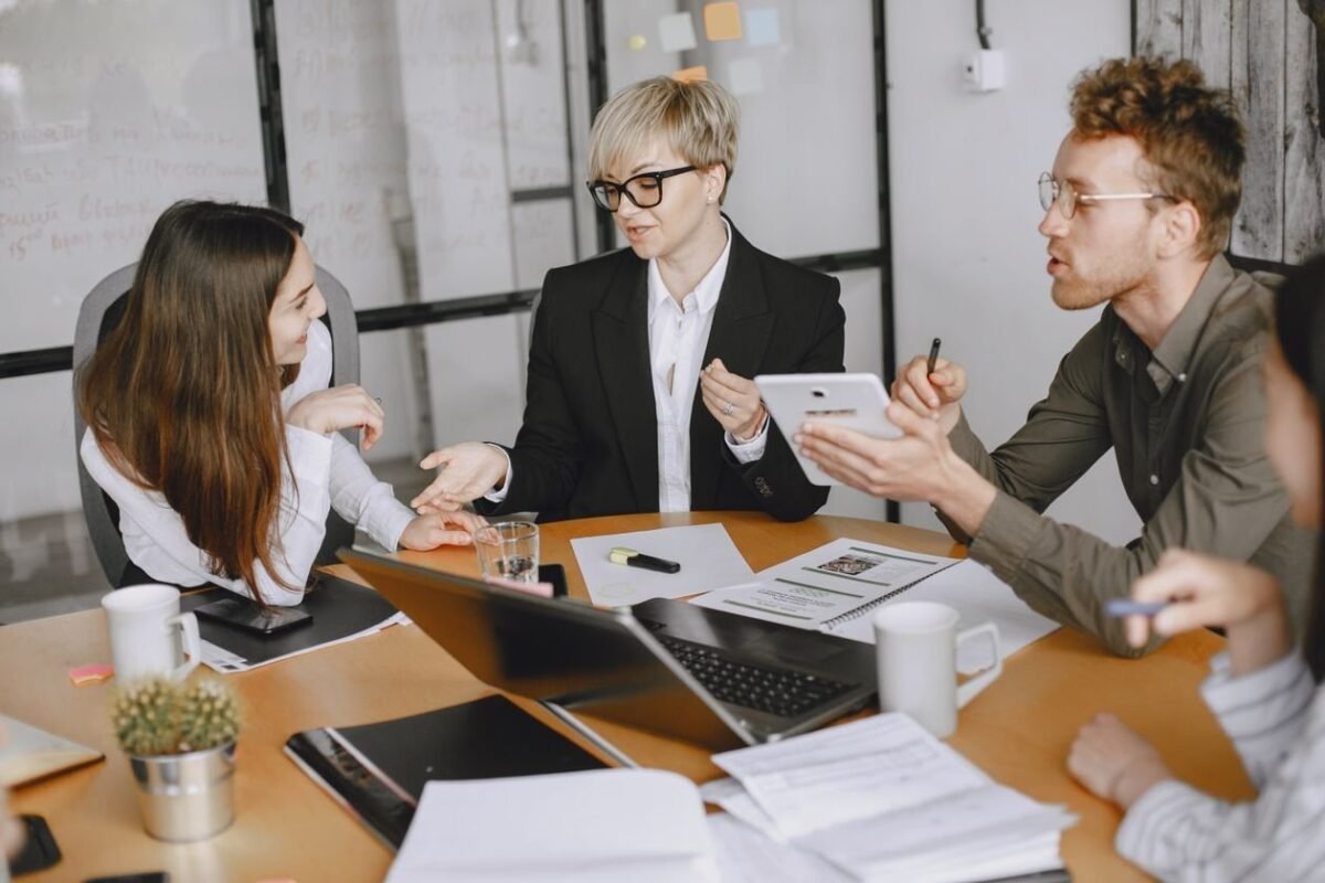 A team meeting in an office — illustrating work handover