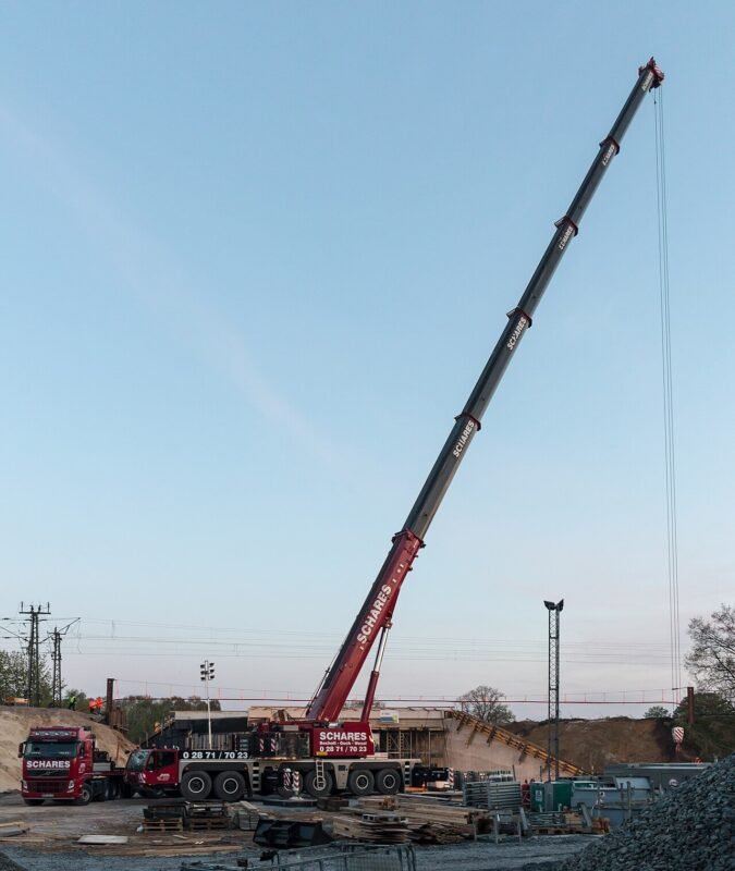 A construction crane over an unfinished building site