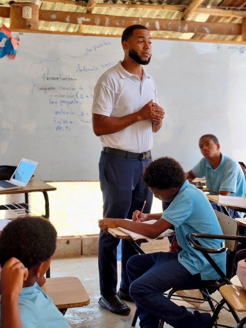Students raising hands in class — illustrating preschool and general education operation licenses