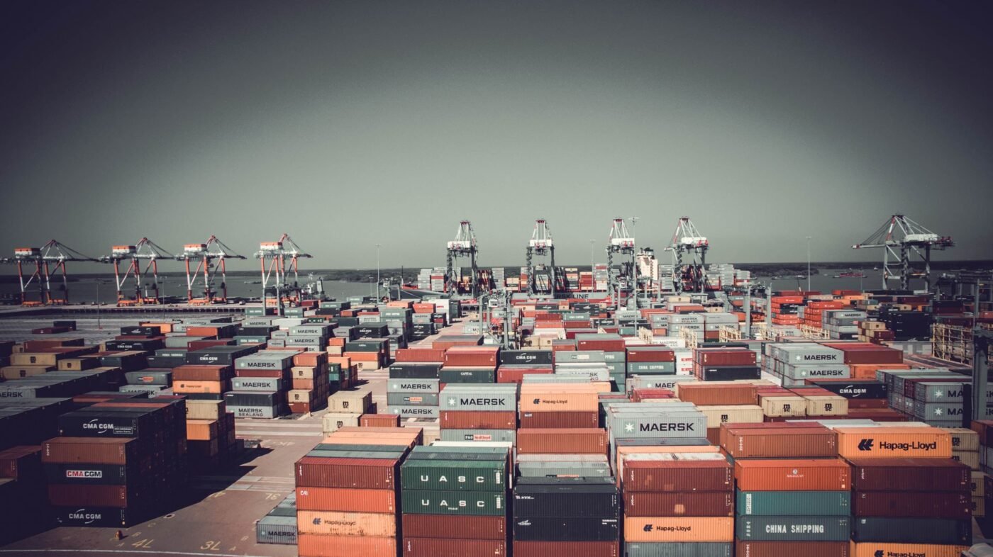 Green, yellow and red customs inspection lanes — aerial view of stacked containers at the port