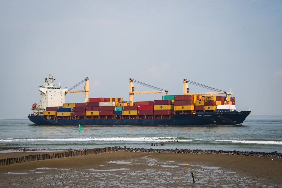 Export customs procedures — fully loaded container ship sailing on the ocean