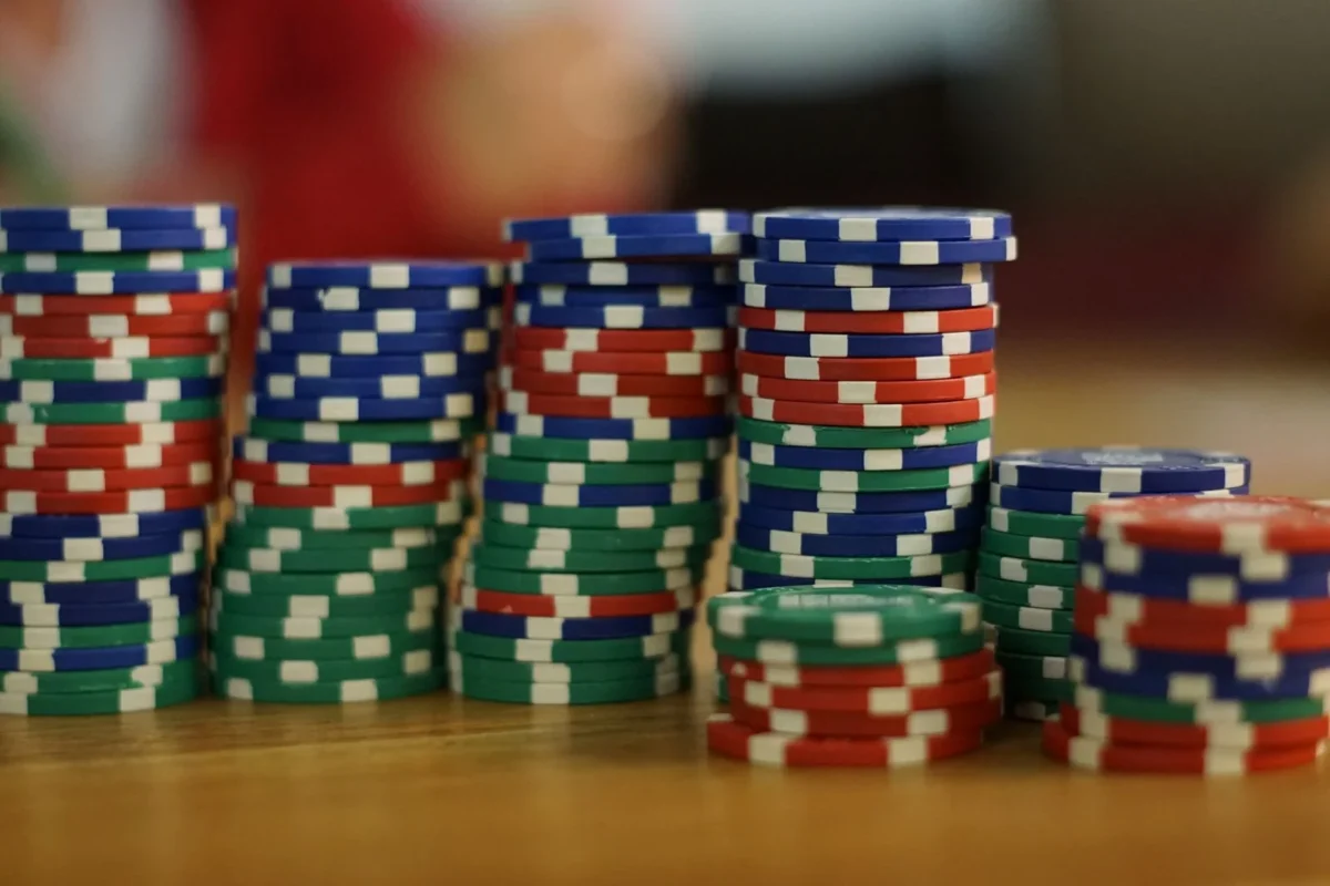 Casino business licensing — stacks of colorful poker chips on a green table