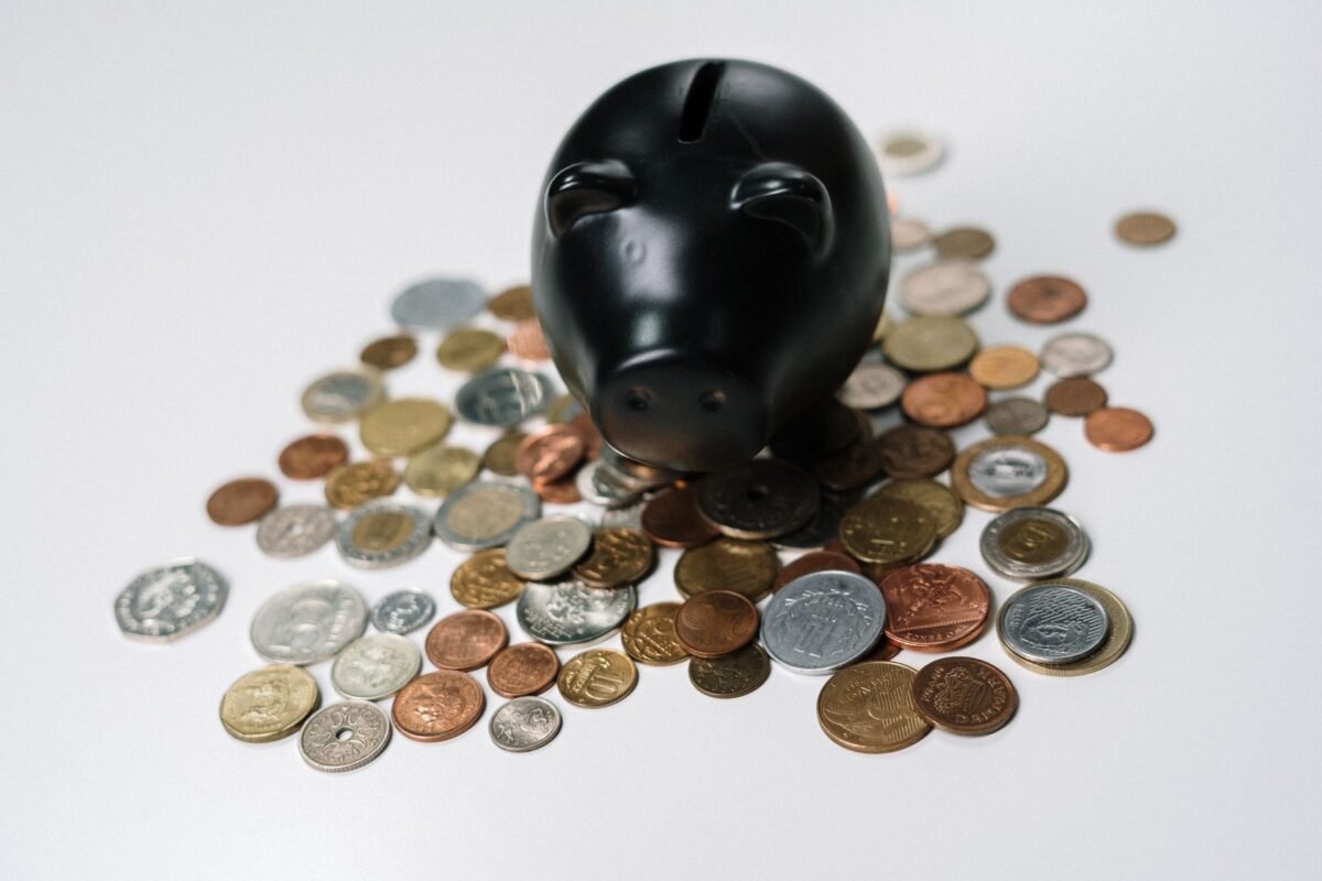 Piggy bank surrounded by coins — illustrating quarterly provisional CIT payment, no people visible