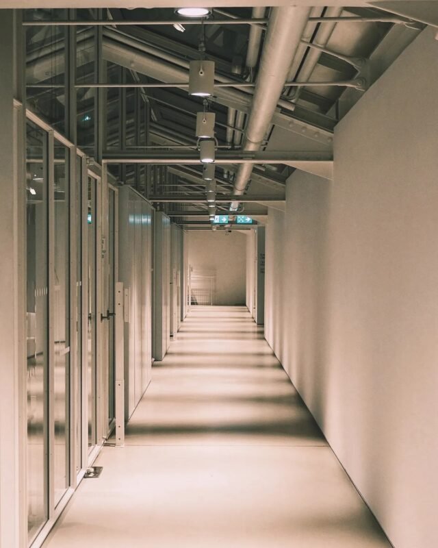 Tax code suspended for absence from registered address in Vietnam — empty office corridor illustration