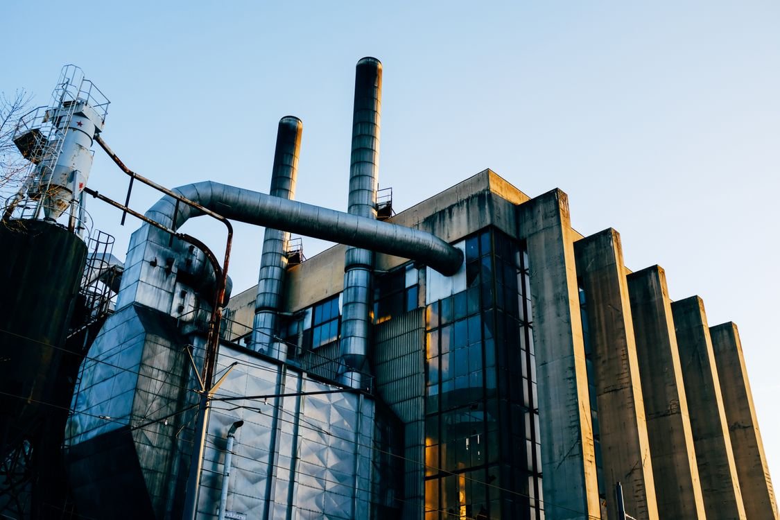 Modern industrial factory building — illustration for the article on factory construction permit costs in industrial zones