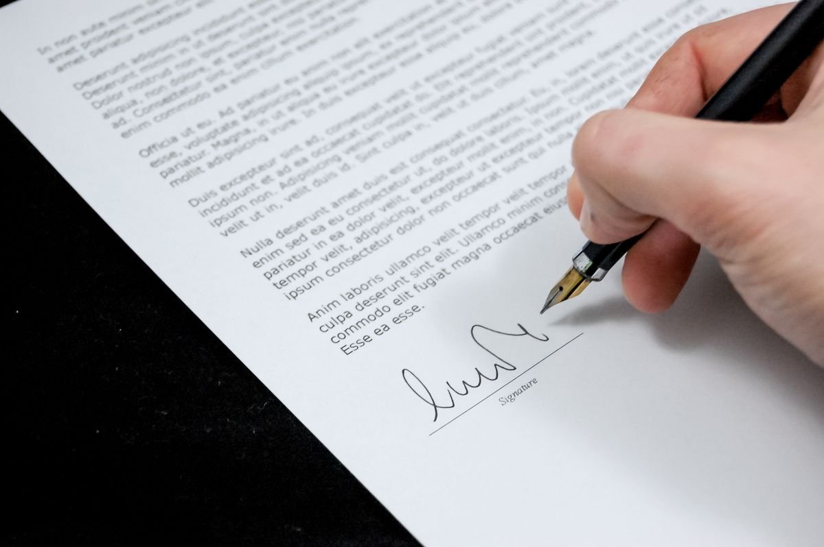 Making a will — hand signing a will document with a fountain pen