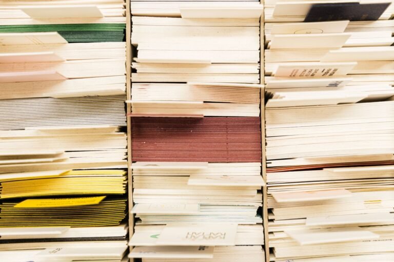 Close-up view of stacked documents in various colors organized in a file system
