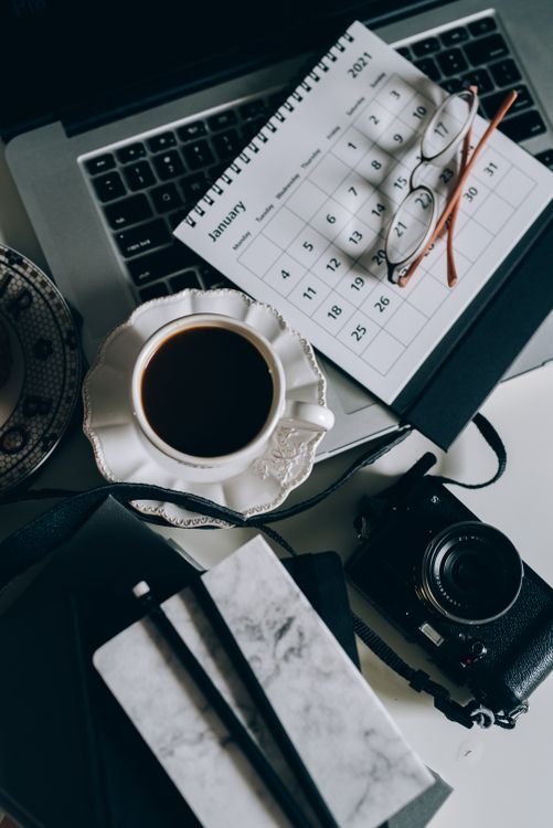 Desk calendar and laptop flat lay — annual compliance costs for FDI companies in Vietnam 2026