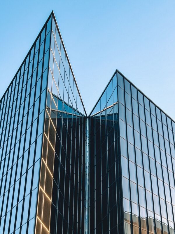 Modern corporate office building facade — illustration for the article on an FDI company moving its headquarters out of an industrial zone