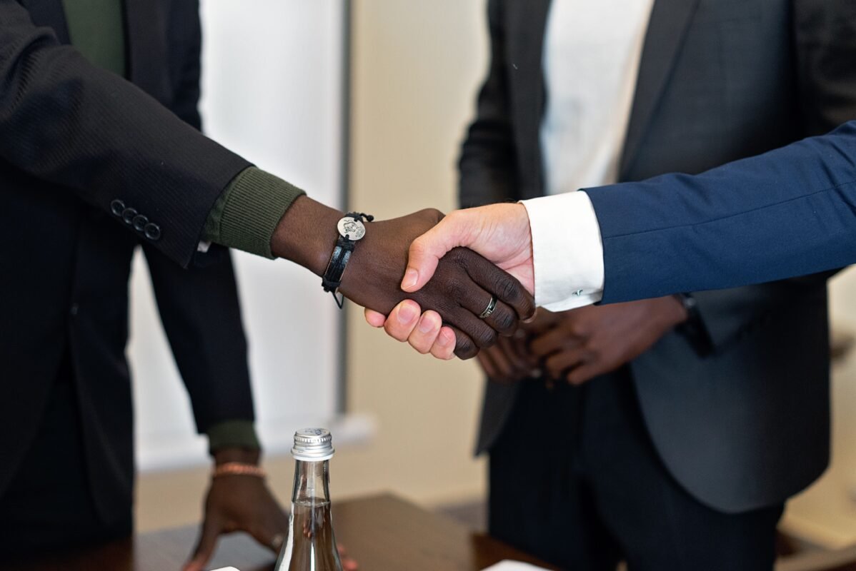 Investment Support under the 2025 Investment Law: What Can FDI Enterprises Receive Beyond Incentives? 1 Close-up of two people shaking hands at a business meeting — illustration for the article on investment support beyond incentives for FDI enterprises