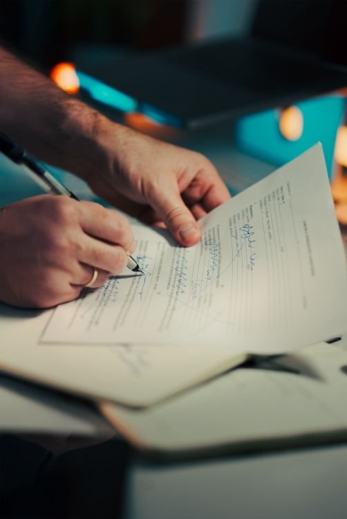 Ending Failed Probation: How Can Employers Terminate Lawfully? 1 Signing employment contract — hands with pen