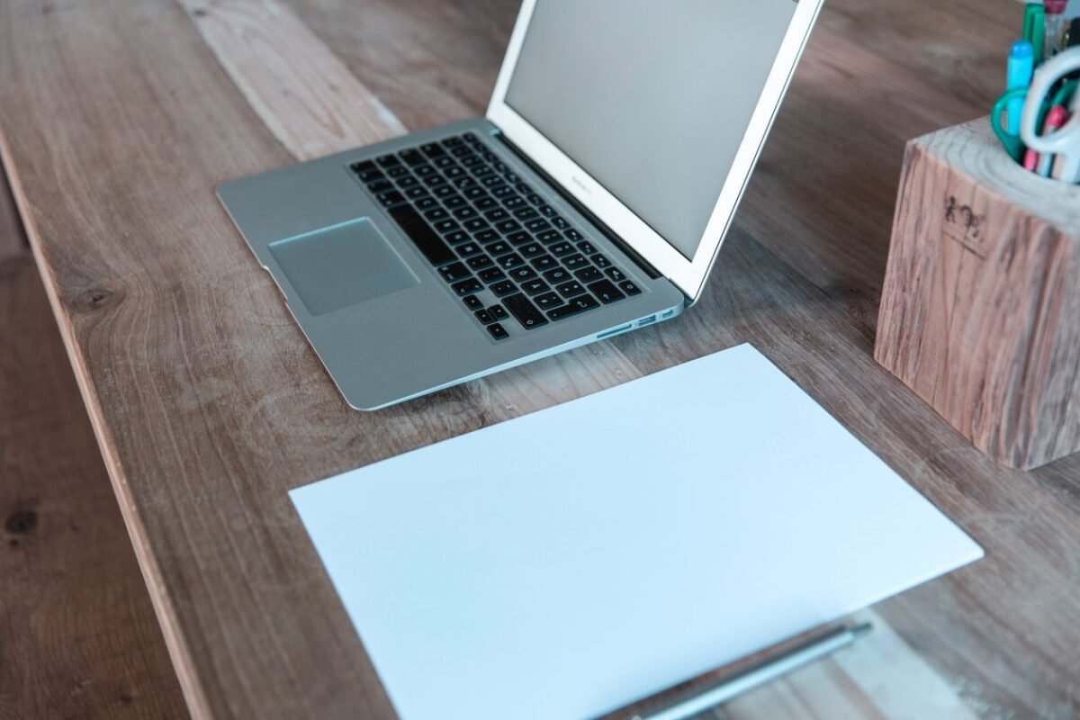 Clean desk with laptop and notebook — illustrating IP preparation for startup fundraising