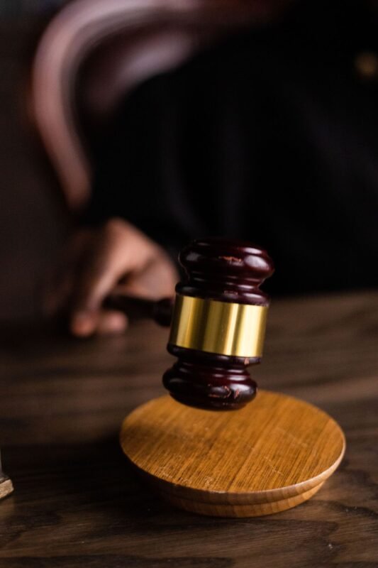 Judge gavel on courtroom desk, symbol of justice