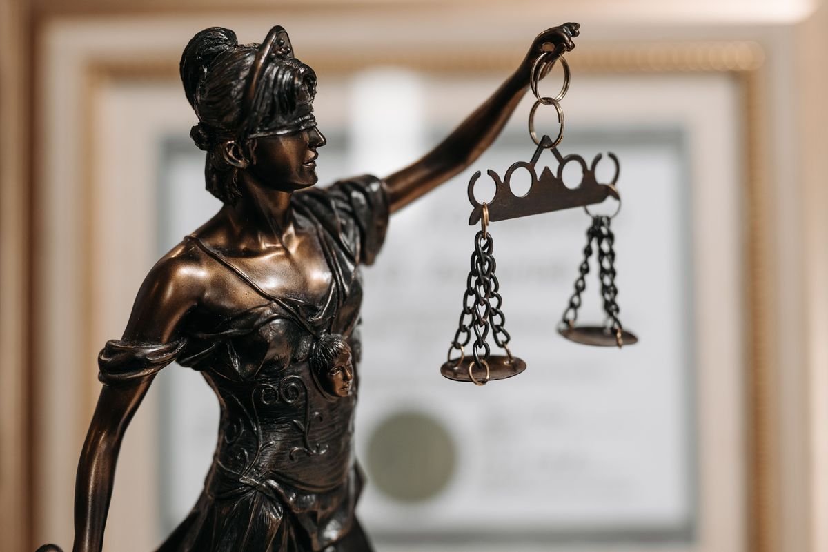 Scales of justice and law books, right to defense
