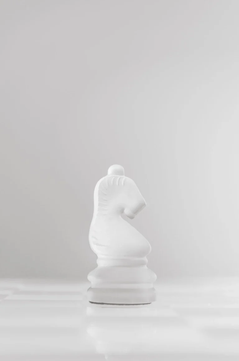 White chess knight on a minimalist background — illustration for an article comparing M&A deal structures