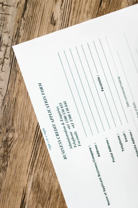 Business credit application form on a rustic wooden table