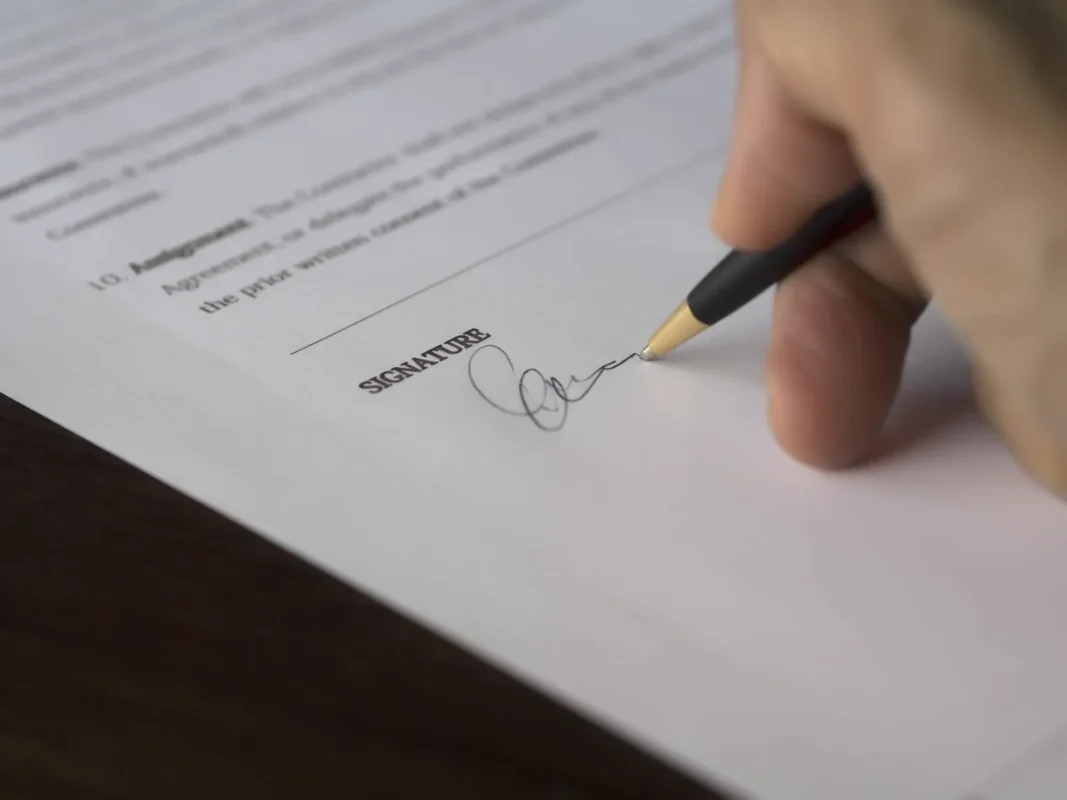 Signing a document — illustrating a labor contract termination decision