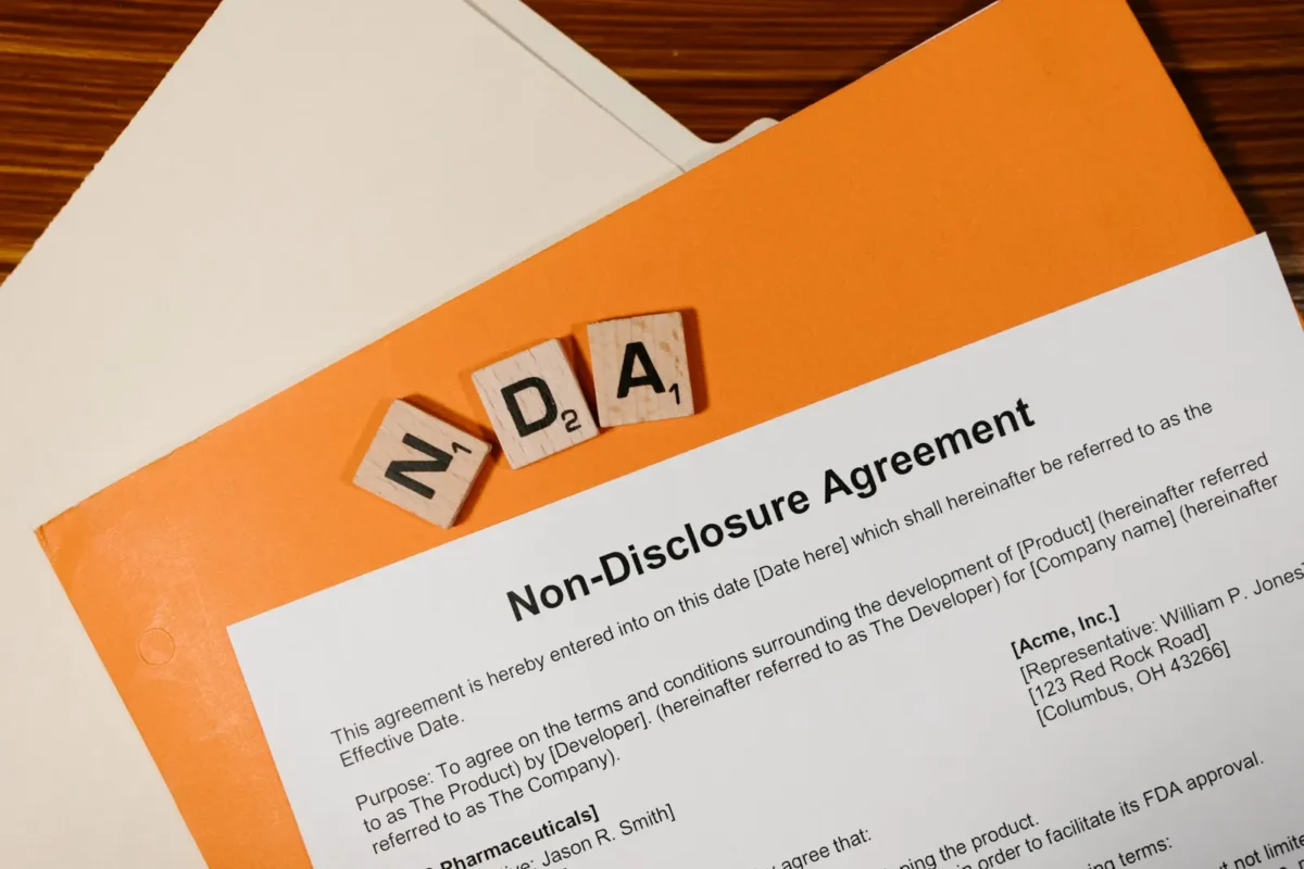 Non-disclosure agreement with NDA letter tiles; no people