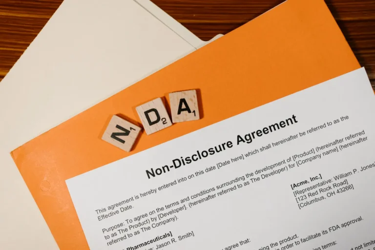 Non-disclosure agreement with NDA letter tiles; no people