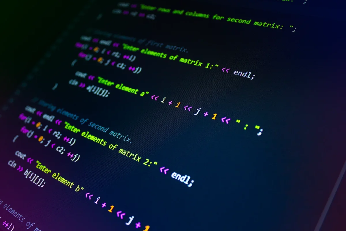 Foreign Client Claims Damages for Software Defects: How to Limit Liability 1 Close-up of C++ source code on a dark screen; no people