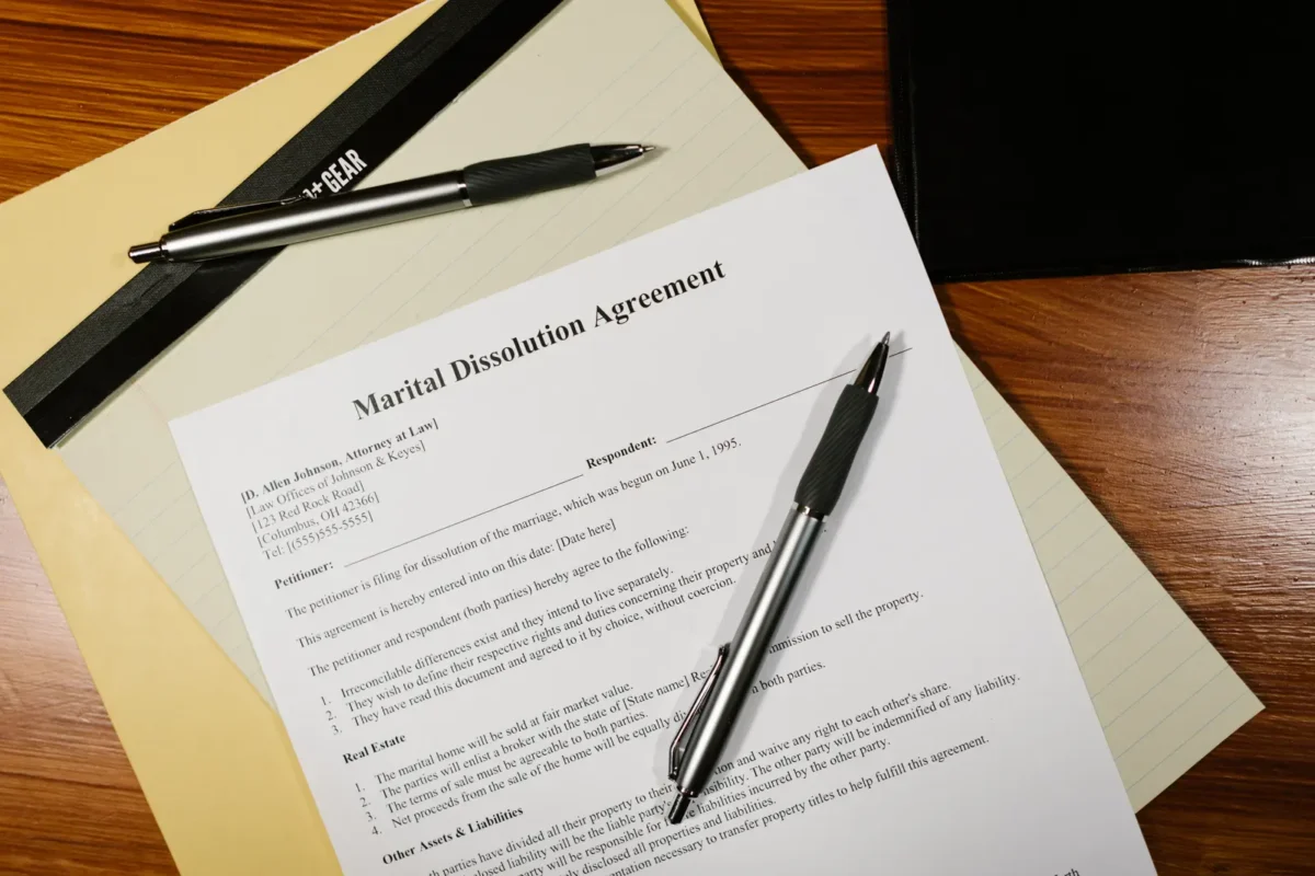 Married Couple Bought a House Titled in One Name: How Is It Divided on Divorce 1 Marital dissolution agreement with pens on a desk; no people