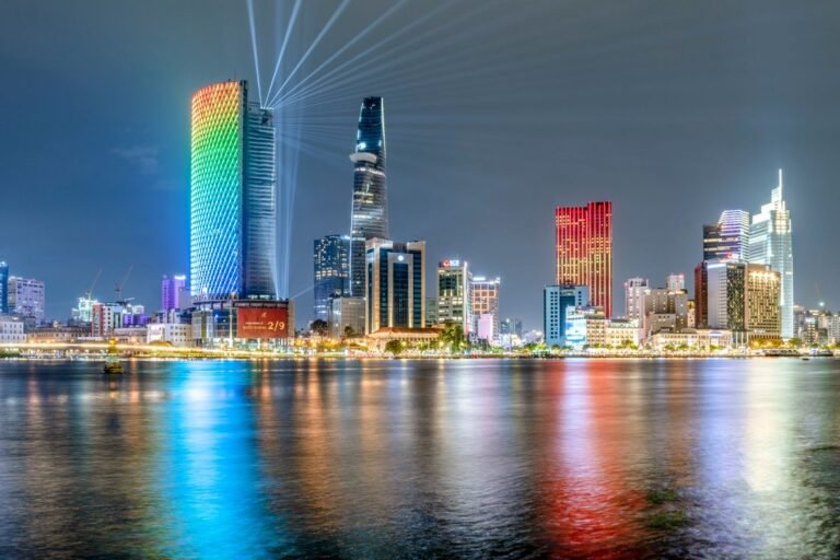 Illuminated Bitexco Tower by the Saigon River at night