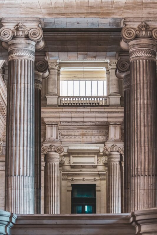 Neoclassical courthouse interior with stone columns, illustrating corporate criminal liability for employees' offences