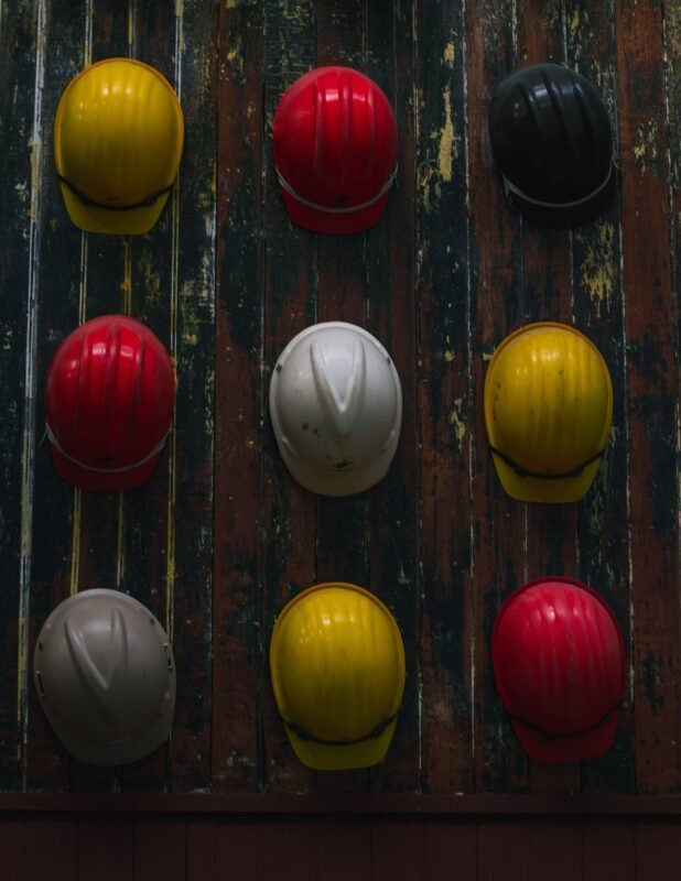 Safety helmets hanging on a wall — illustrating occupational safety duties and the crime of violating labor safety regulations (Article 295)