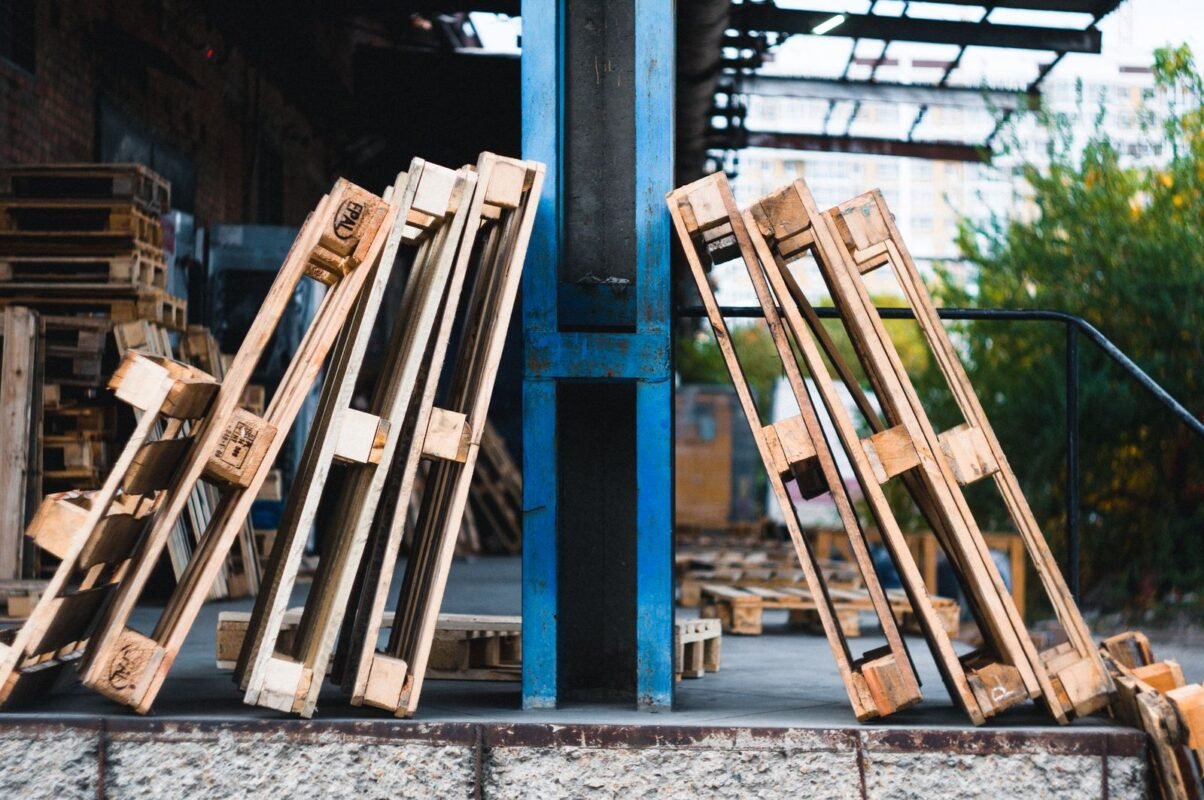Shipping containers and wooden pallets in a logistics warehouse