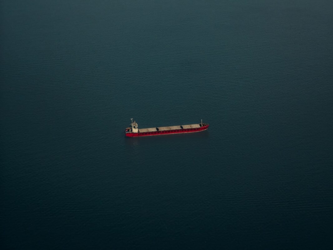 Container vessel carrying stacked containers at sea