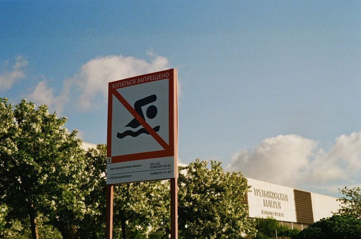 Yellow warning sign — illustrating work-related injury compensation costs employers must bear, no people