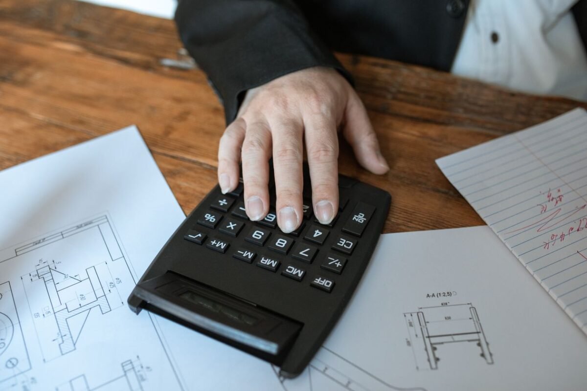 Calculator resting on tax documents — illustrating first-year corporate income tax finalization for FDI enterprises, no people