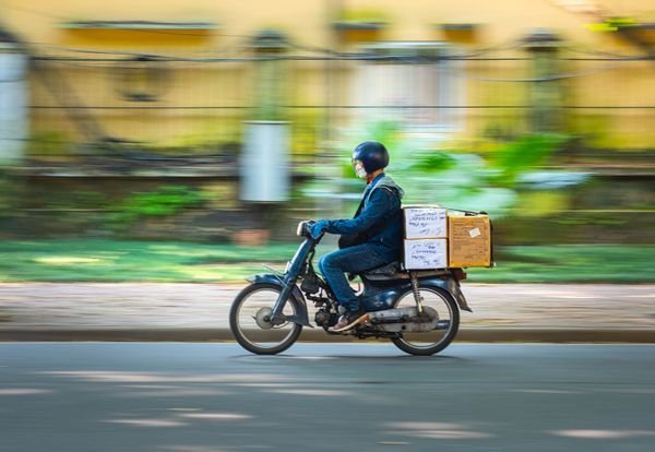 Food delivery rider on a motorbike (illustrative)