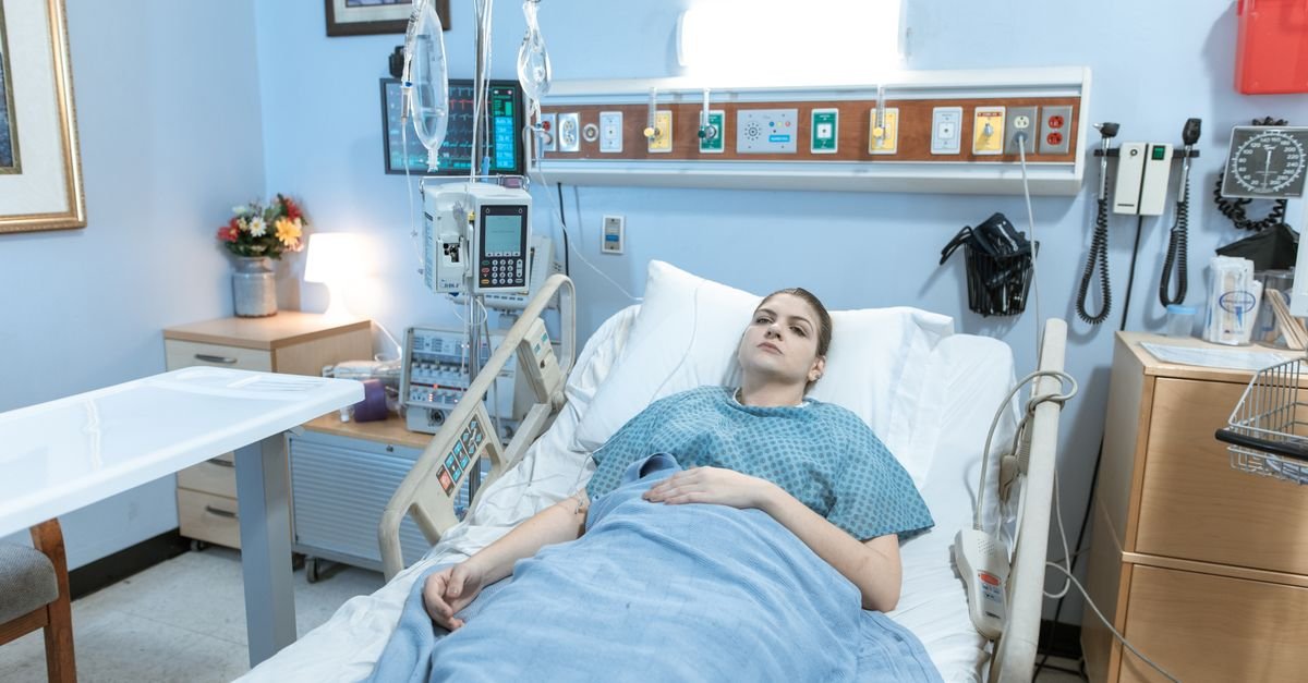 Patient in a hospital bed (illustrative)