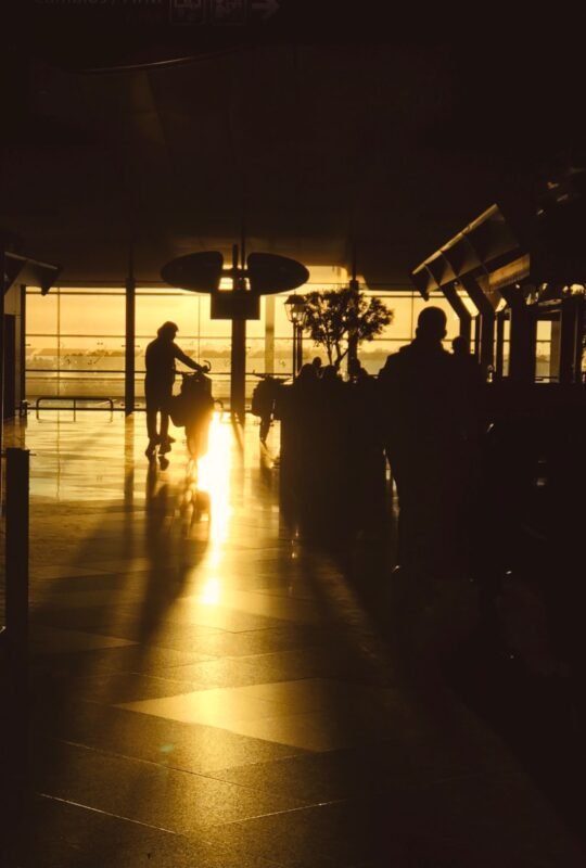 Silhouette of Travelers in Golden Airport Sunset