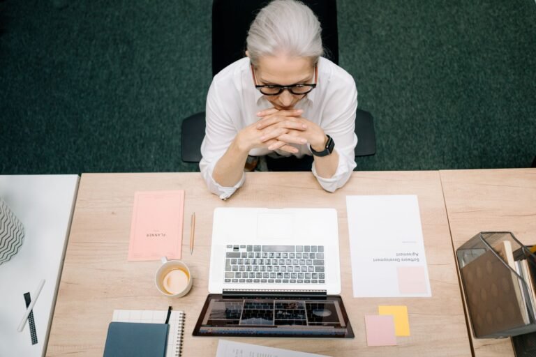 Woman with Gray Hair Sitting in Front of a Laptop