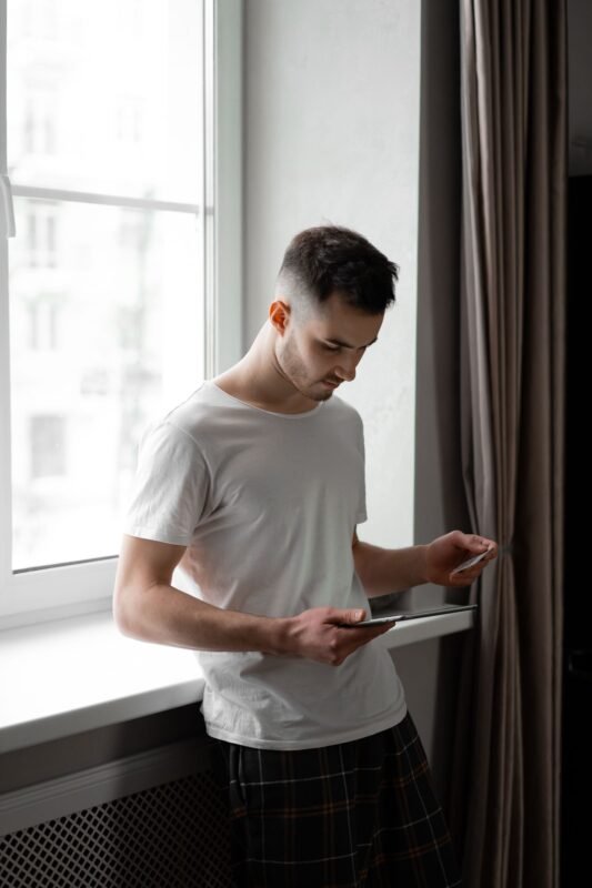 Payment Deadlines for Capital Transfers and Breach Penalties in Vietnam 1 A Man Using a Tablet and Credit Card for Online Transaction