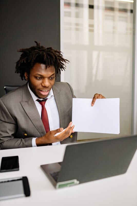 Man in Formal Attire holding a Paper