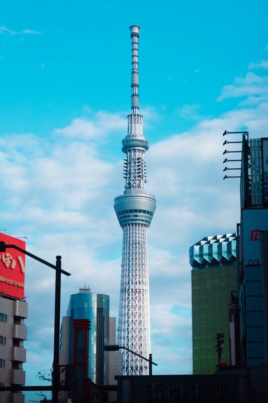 A breathtaking view of the iconic Tokyo Skytree, towering over the cityscape with clear blue skies